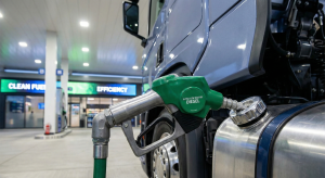 Commercial truck refueling with EN590 diesel at a modern filling station, highlighting automotive fuel specifications.