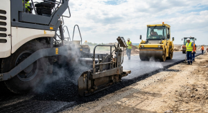 Road construction machinery laying hot bitumen asphalt, demonstrating penetration grade applications in infrastructure projects.